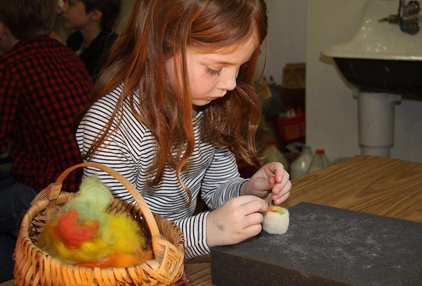Lower school student learning about fiber arts